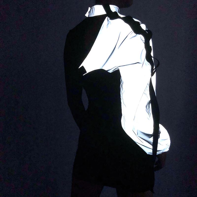 One shoulder reflective cami top for women, showcasing a neon halter design and trendy asymmetrical style.