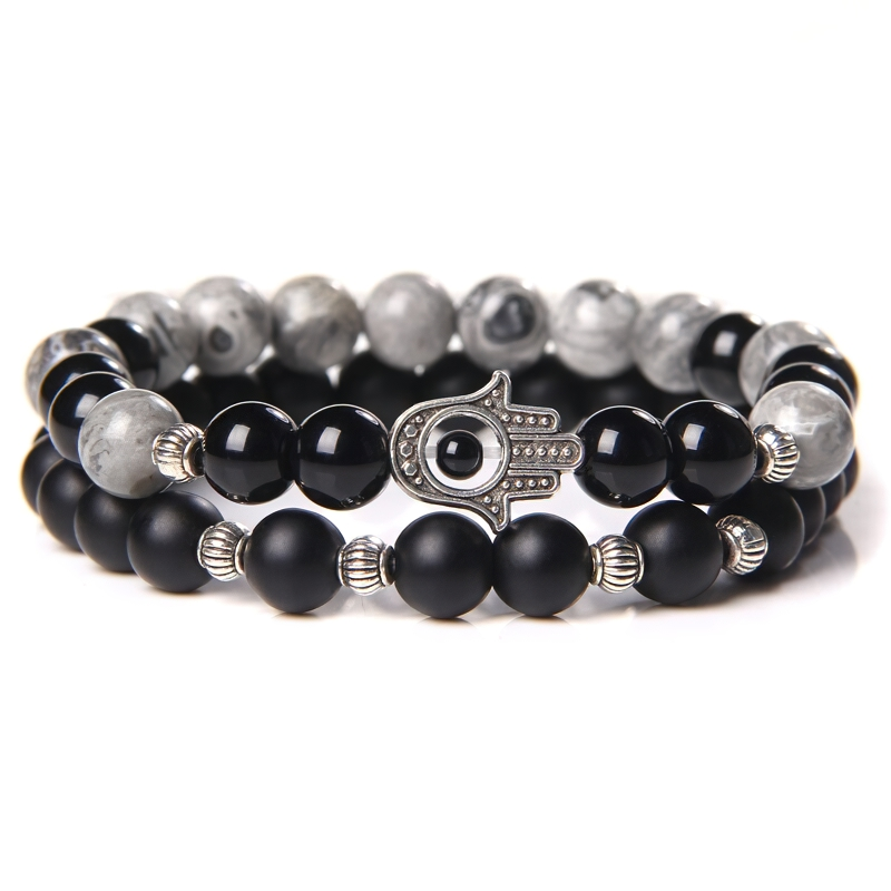 Unisex onyx stone bracelet featuring a mix of black and gray beads with a decorative metal charm, perfect casual accessory.