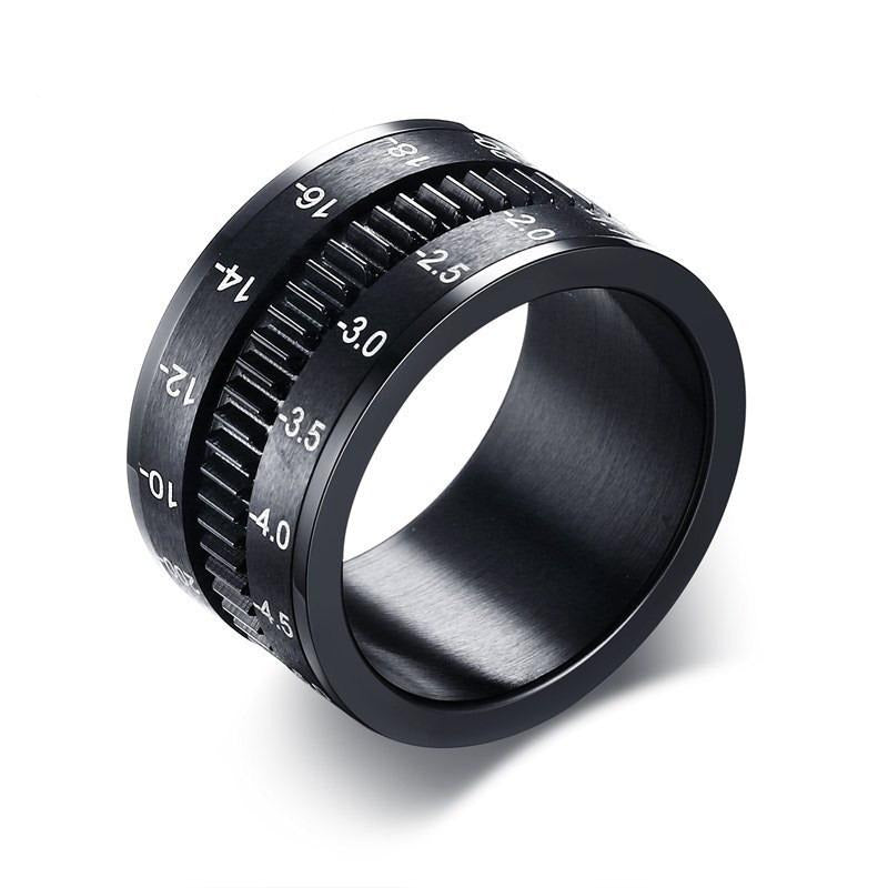 Stainless steel black camera lens ring resembling a lens, perfect alternative jewelry for photographers.