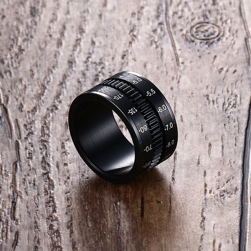 Sleek black stainless steel camera lens ring, perfect alternative jewelry for photographers and creatives.