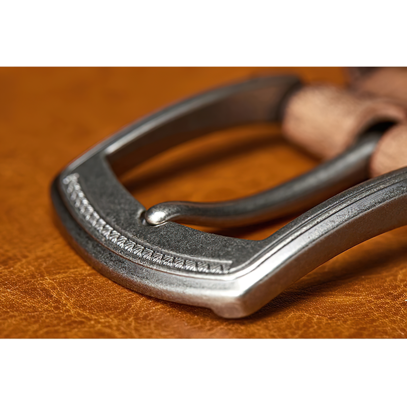 Close-up of an alloy belt buckle on a leather background, showcasing stylish design for casual belts.