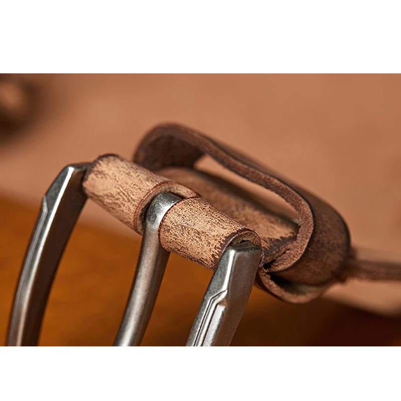 Close-up of a handmade cowhide belt with an alloy buckle, showcasing its stylish texture and craftsmanship.