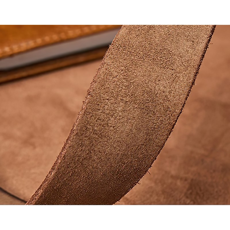 Close-up of a soft brown cowhide belt showing its smooth texture for a stylish casual look.