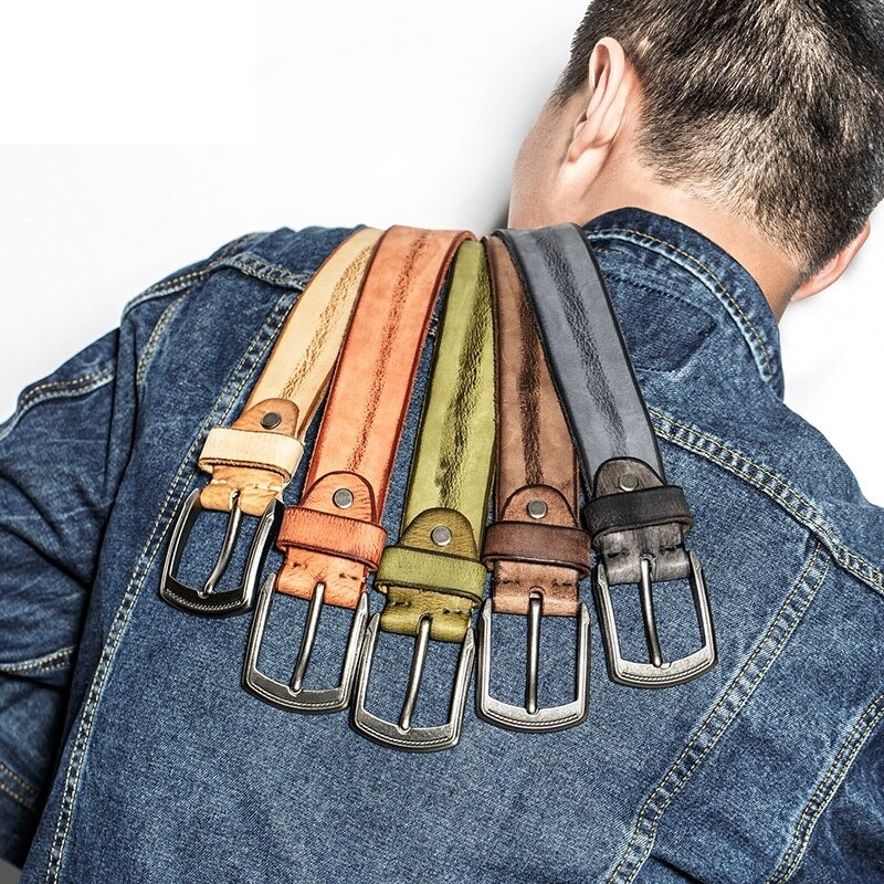 Stylish cowhide belts in various colors draped over a shoulder, perfect for casual outfits and everyday wear.