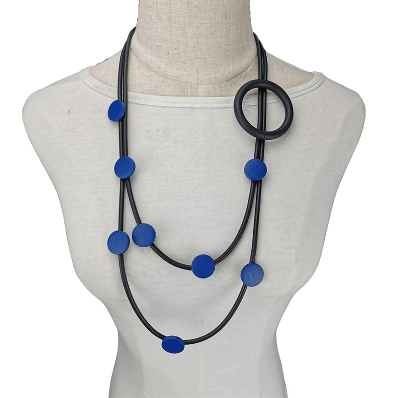 Stylish women's rubber necklace featuring a unique gothic and ethnic design with blue accents.