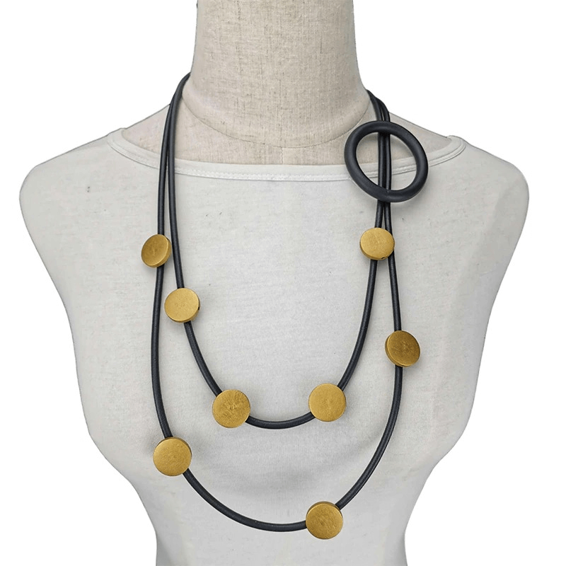 Stylish gothic rubber necklace for women featuring gold accent discs and a unique loop design, perfect for ethnic-themed outfits.
