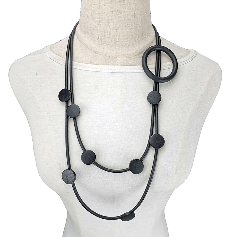 Stylish women's gothic rubber necklace with ethnic design, featuring circular and disk elements in black.