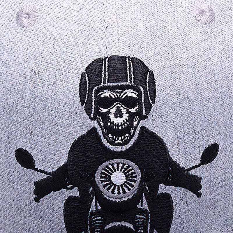 Embroidered skeleton on a gray baseball cap, wearing a helmet and riding a motorcycle, perfect for punk rock style.