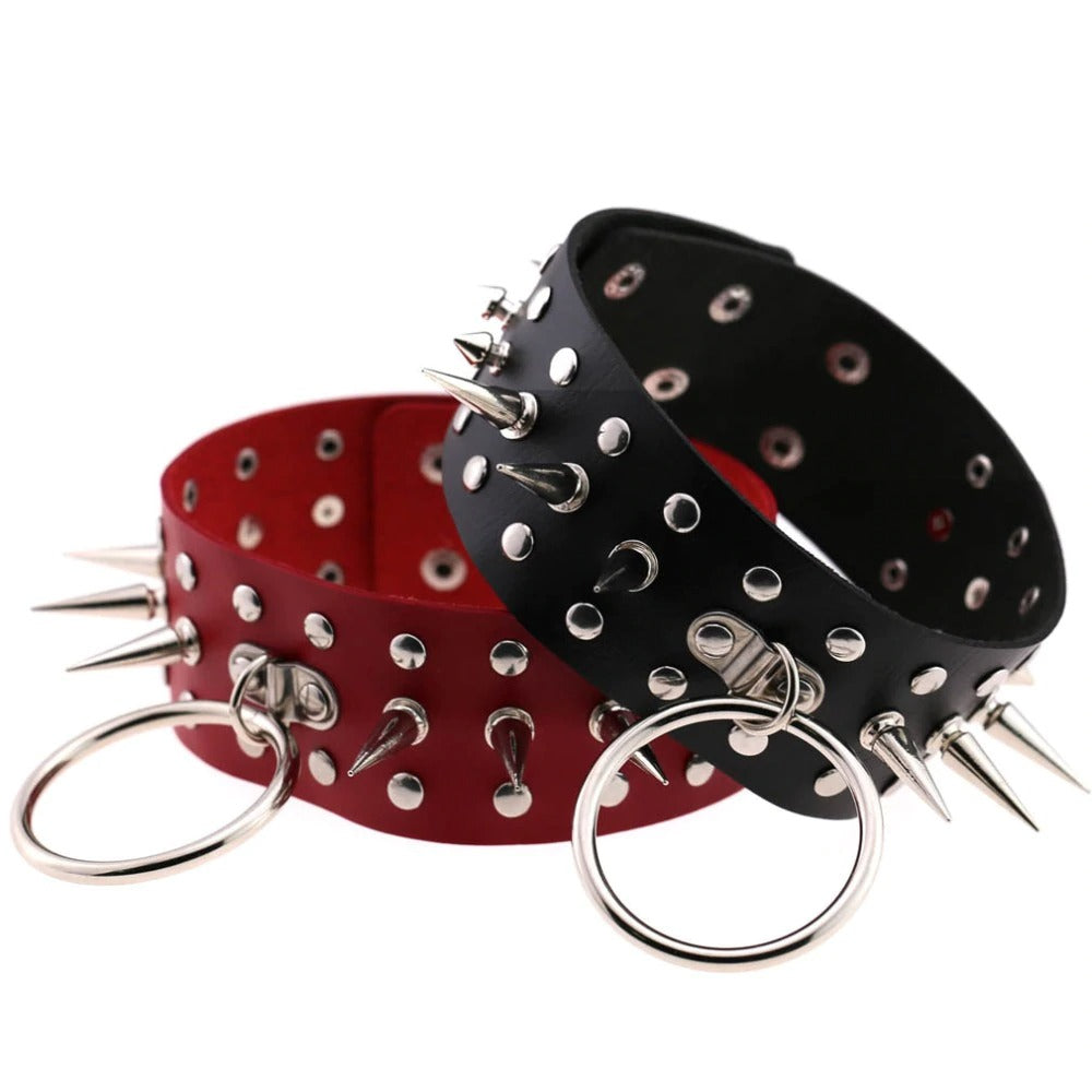 Oversized spike choker necklaces in red and black faux leather, featuring metal spikes and rings, perfect for gothic and rock styles.