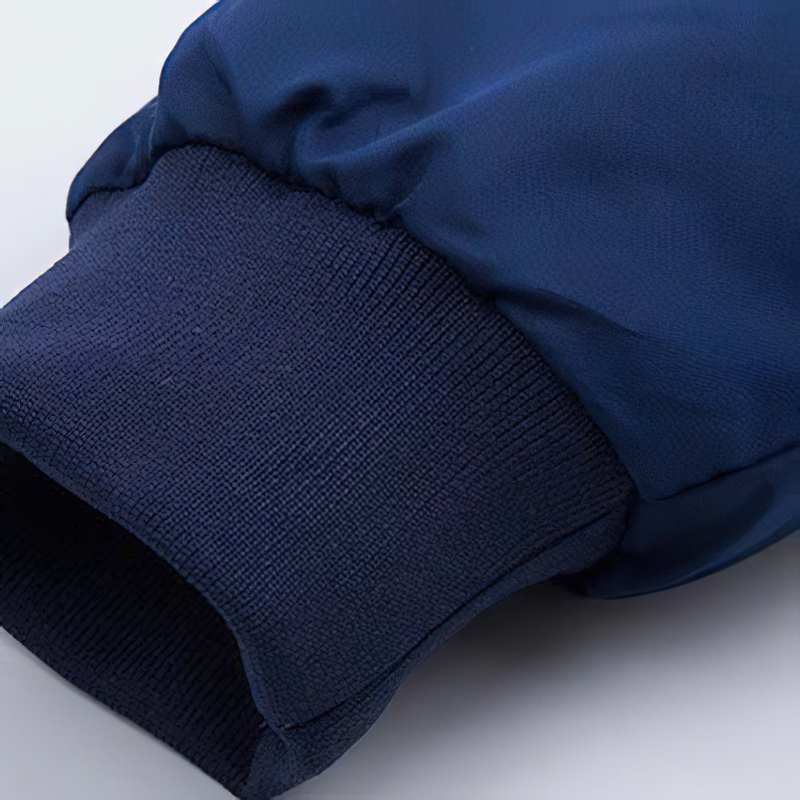 Close-up of navy padded jacket sleeve with ribbed cuff, showcasing modern casual style and comfort.