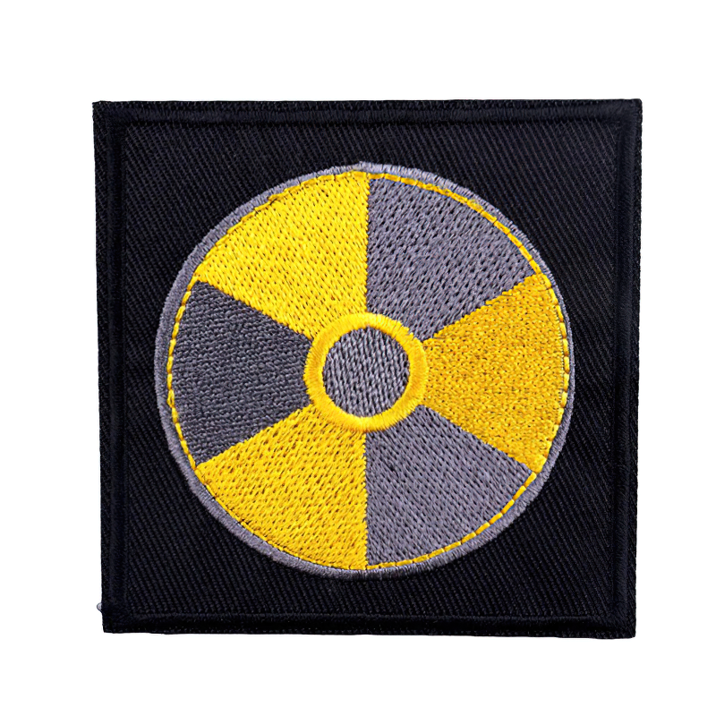 Unisex embroidered patch featuring a danger radiation symbol in yellow and gray on a black background.