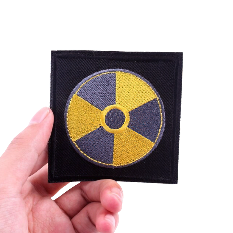 Unisex embroidered patch featuring a danger radiation symbol for alternative fashion outfits.