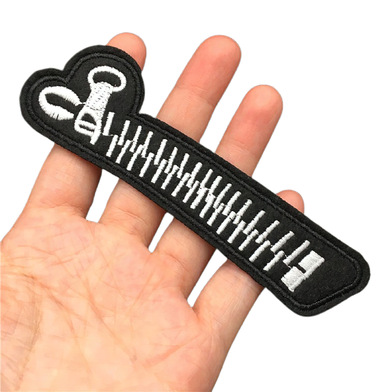Gothic zipper-shaped patch held in hand, perfect for stylish unisex clothing accessories.