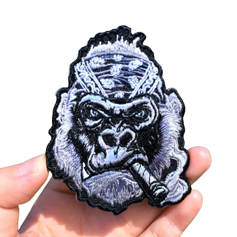 Gothic embroidered patch of a big gorilla with a cigar, perfect for stylish clothing accessories.