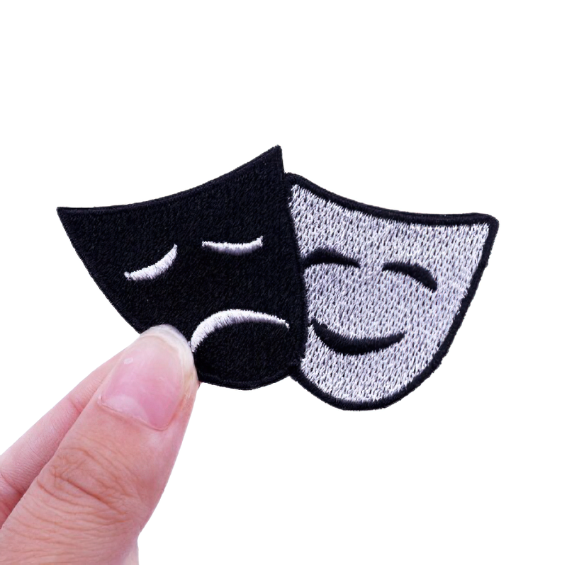 Unisex embroidered theater mask patch showing happy and sad expressions, perfect for alternative rave outfits.