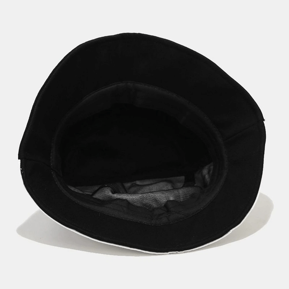 Interior view of black patchwork graffiti cotton bucket hat, showcasing stylish design and quality materials.
