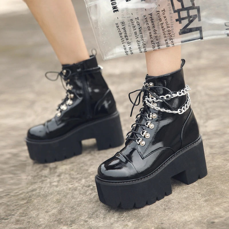 Gothic women's black patent leather platform boots with chain detail and ankle zipper, perfect for fall and winter fashion.