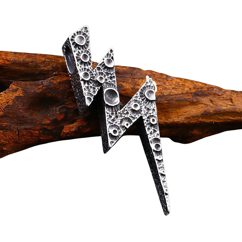 Unisex stainless steel lightning pendant design on wooden background, stylish alternative jewelry accessory.