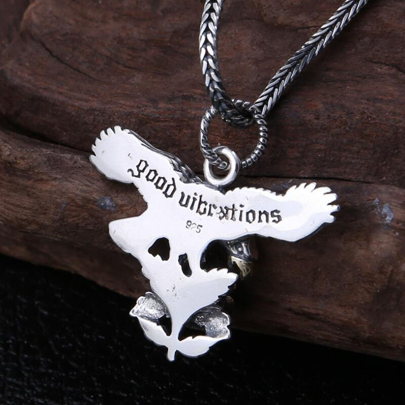 Stylish pendant featuring a silver eagle with the text 'Good Vibrations' and a floral design, perfect for unisex jewelry.