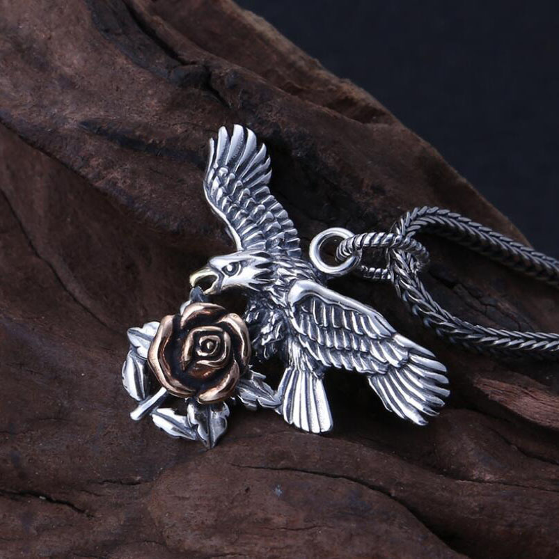 Sterling silver pendant featuring an eagle and a rose, perfect for stylish unisex jewelry.
