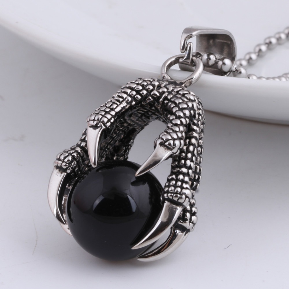 Stainless steel dragon's claw pendant gripping a big black stone crystal, perfect for stylish layering and unique gifts.