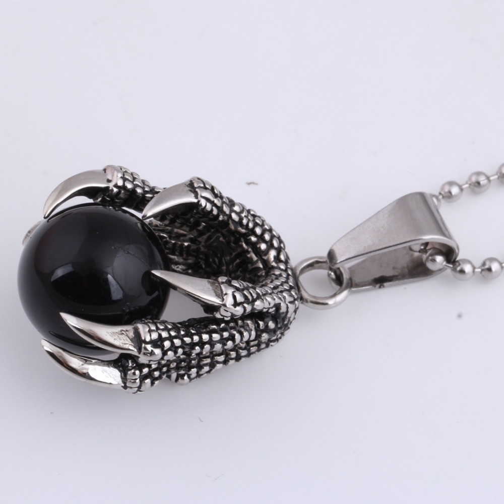 Stainless steel pendant with black crystal held in claw design, perfect for layering or gifting.