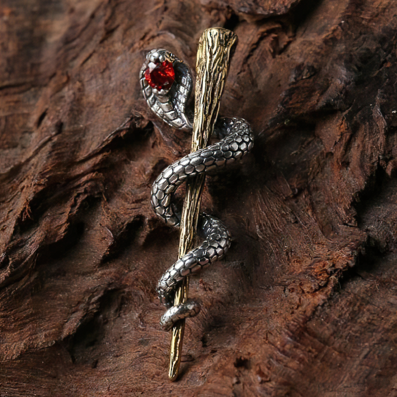 Sterling silver cobra pendant with intricate details and a ruby accent, perfect for alternative jewelry lovers.