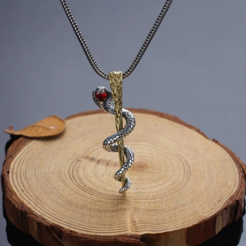 S925 sterling silver pendant with cobra design on wooden background, perfect for alternative jewelry lovers.