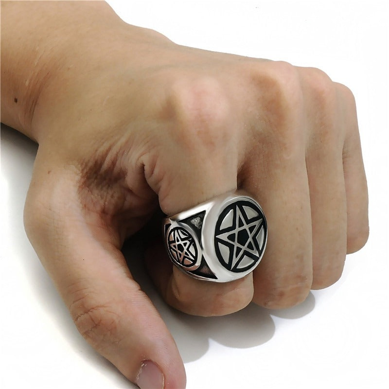 Stylish pentagram pentacle star ring worn on a hand, perfect alternative jewelry for punk and biker aesthetics.