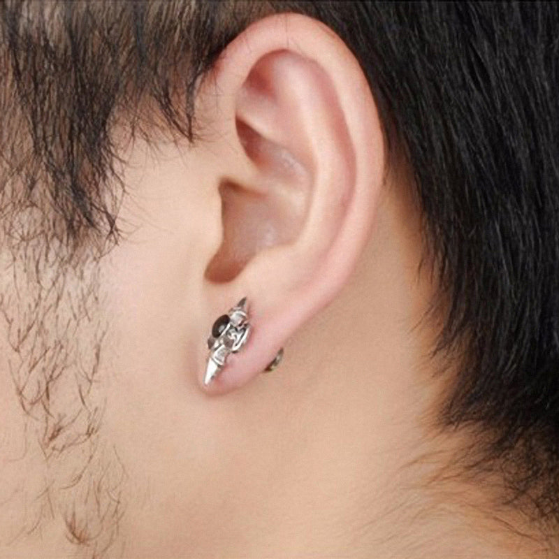 Stylish stainless steel cross design stud earrings shown on a model's ear for alternative fashion lovers.