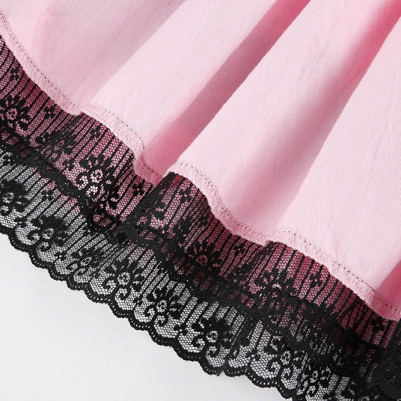 Close-up of pink double layer pleated skirt with black lace trim, perfect for punk-style outfits.