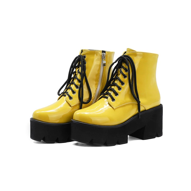 Stylish yellow platform ankle boots with round toe, zipper, and lace-up closure for women, perfect for winter looks.