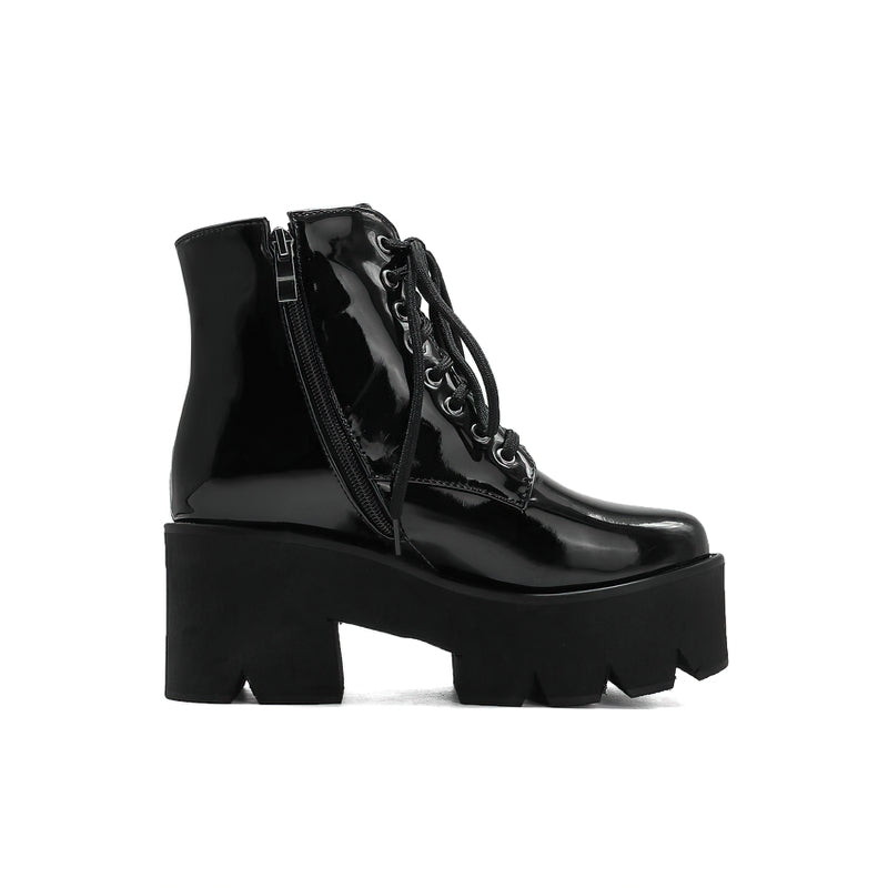Shiny black platform ankle boots with round toe, lace-up front, and zipper closure for stylish winter wear.