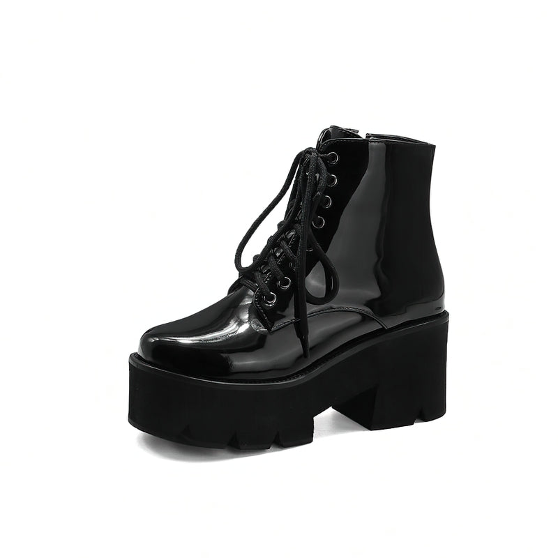 Stylish black platform ankle boots with round toe, lace-up closure, and zip fastening, perfect for winter fashion.