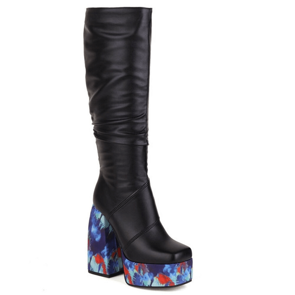 Fashionable black knee-high platform boots with a colorful patterned square heel for trendy casual style.