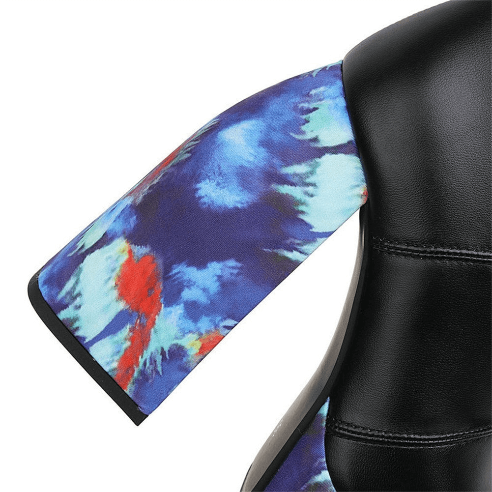 Close-up of a colorful tie-dye patterned sleeve on a black leather chair, showcasing stylish design details.