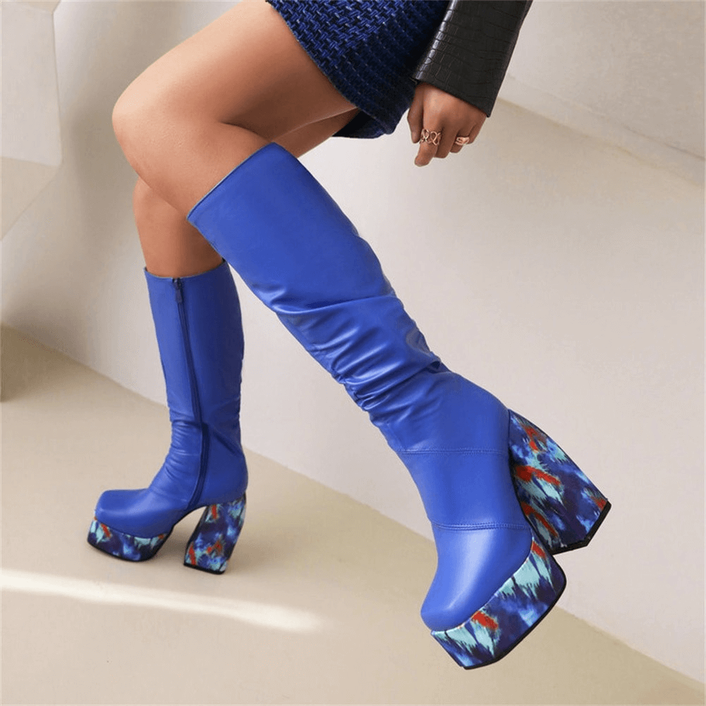 Bold blue knee-high platform boots featuring a stylish floral print heel, perfect for adding flair to any outfit.