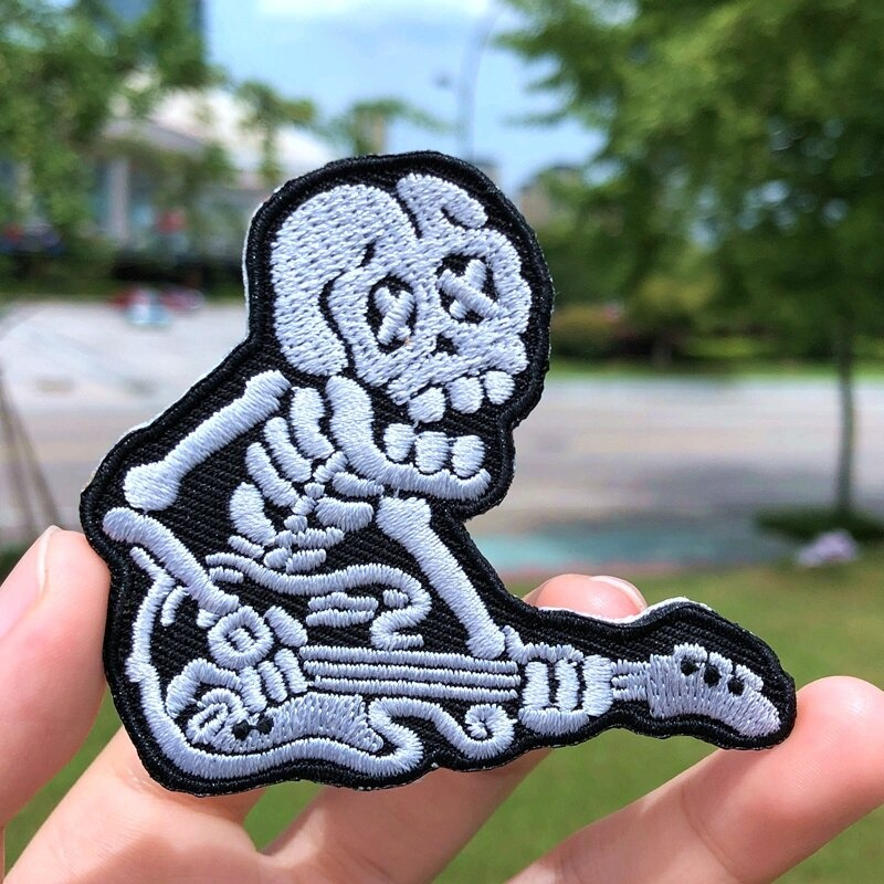 Skeleton playing guitar fusible patch for jackets and bags, stylish rock-inspired accessory.