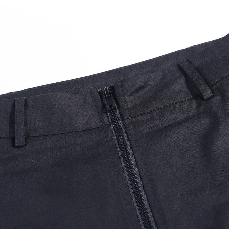 Close-up of the zipper detail on pleated gothic pants, showcasing high waist and sleek black fabric for a trendy autumn look.