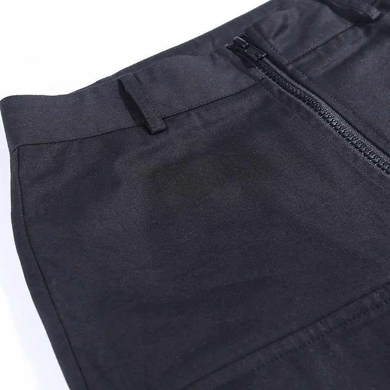 Close-up of pleated gothic pants for women featuring a zipper and stylish patchwork pockets.