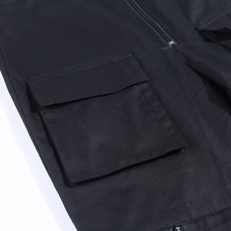 Close-up of the patchwork pocket on gothic style women's pants in black fabric with a zipper.