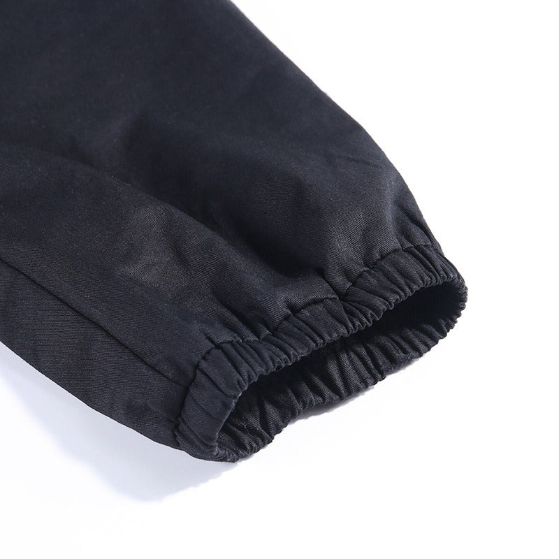 Close-up of elastic cuff on black pleated Gothic pants for women's autumn fashion.