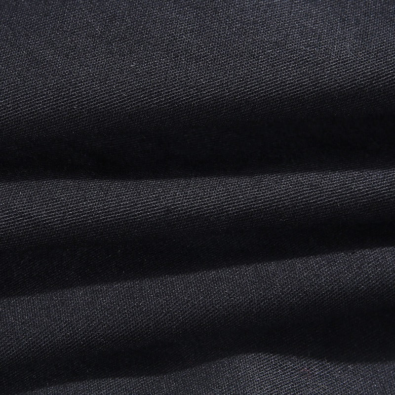 Close-up of black fabric showcasing smooth texture, perfect for stylish autumn gothic pants.