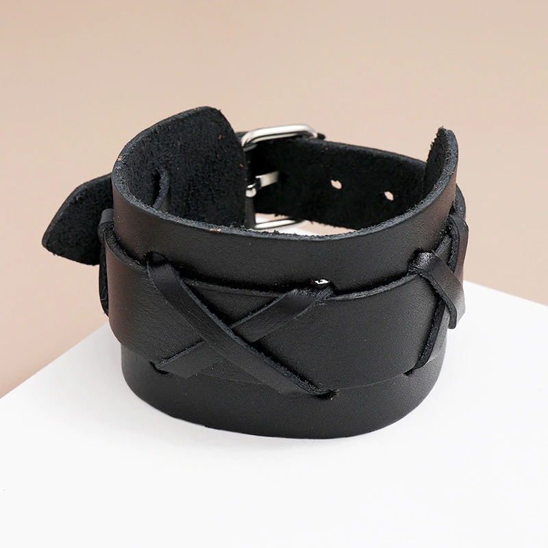 Wide unisex genuine leather bangle bracelet with a punk style, adjustable and available in classic black.