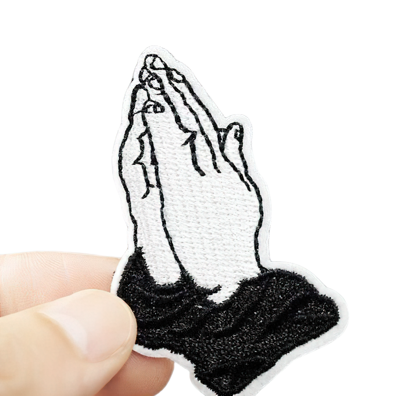 Stylish embroidered 'Praying Hands' patch for clothing, perfect unisex accessory to elevate your outfit.