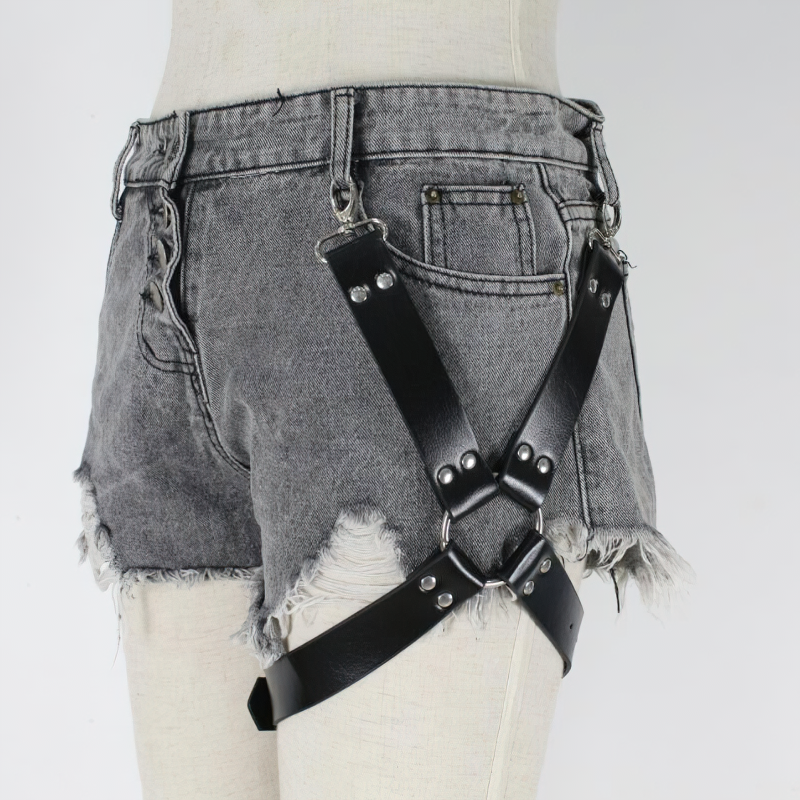 Trendy PU leather belt harness on denim shorts, perfect unisex accessory for alternative fashion looks.