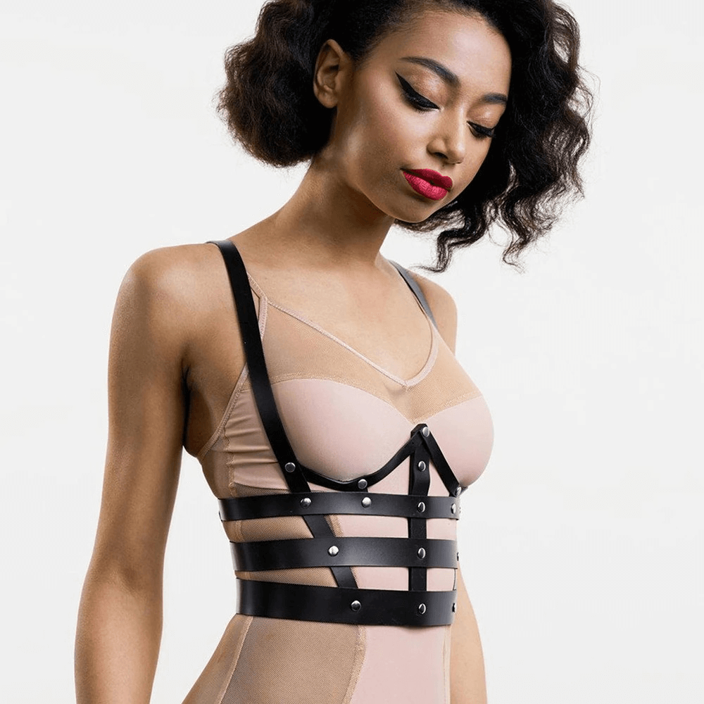 Stylish lady wearing a black PU leather chest harness, showcasing a chic and edgy lingerie look with metal button accents.