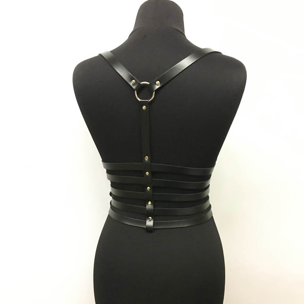 Black PU leather chest harness with silver fittings, punk-style accessory highlighting women's figure, shown on a mannequin.