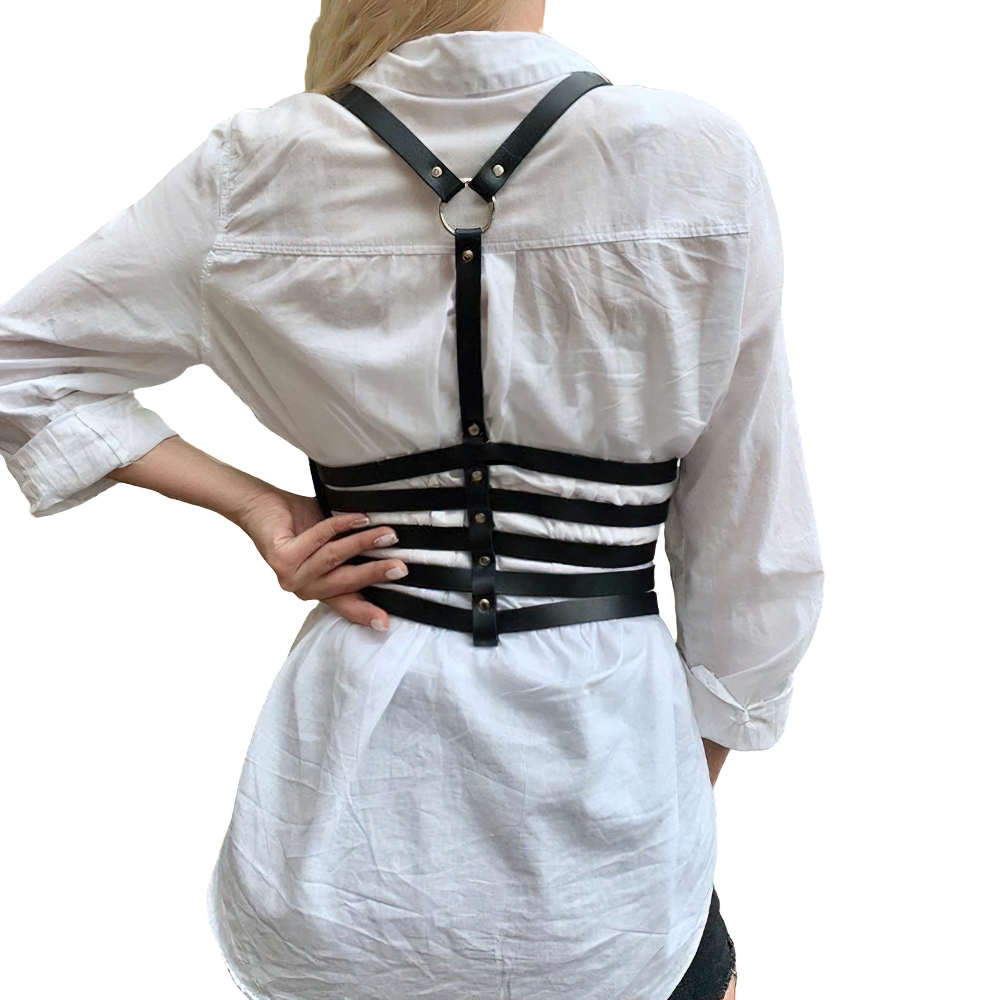 Woman wearing black PU leather chest harness over a white shirt, showcasing punk-style fashion with silver fittings.