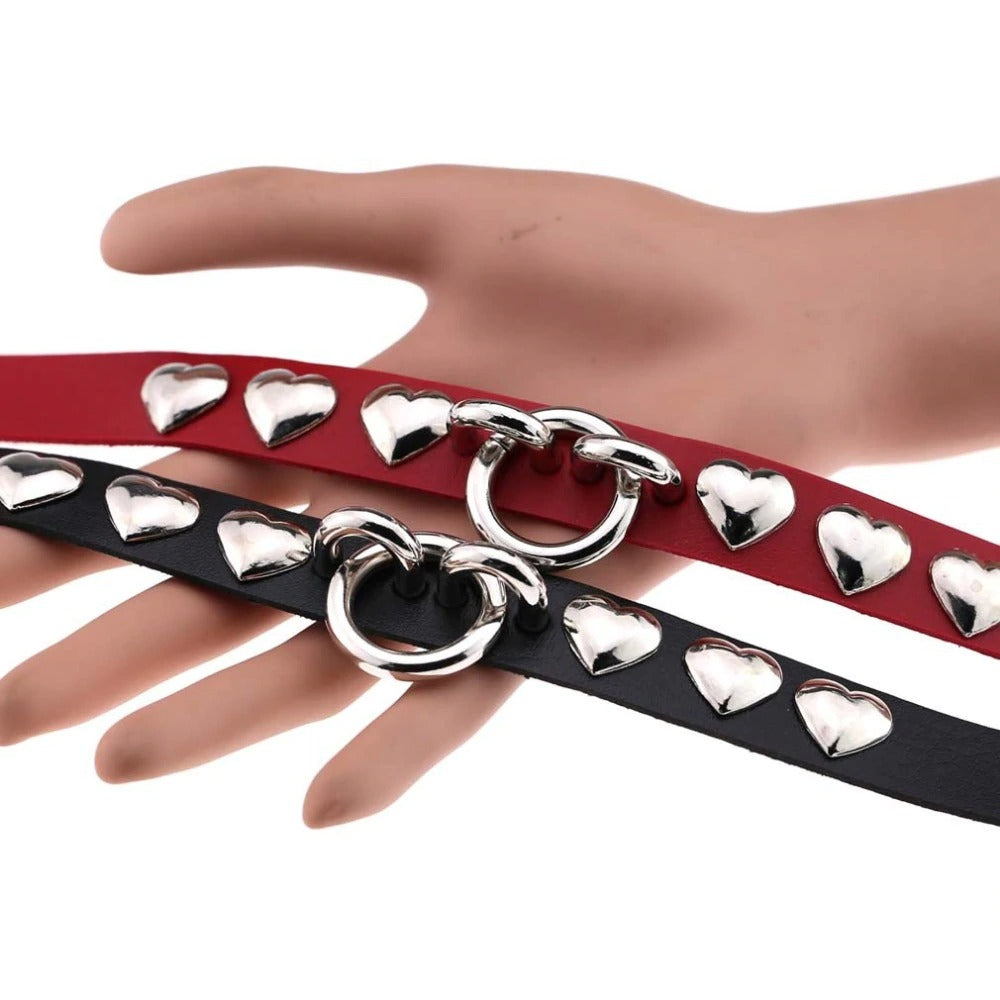 Gothic PU leather chokers with silver heart studs displayed on a hand, perfect vintage accessories for parties.